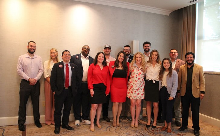A group of people standing for a photo, likely during an event or meeting.